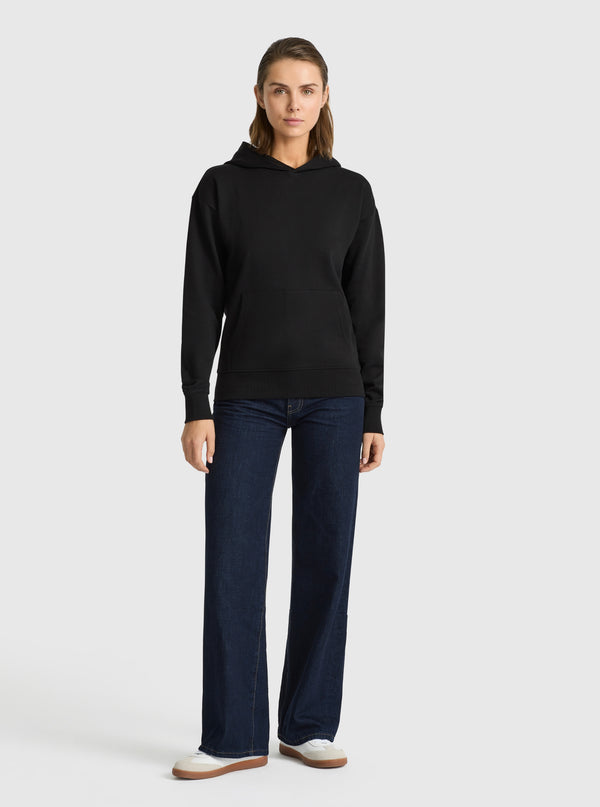 Black|Good Earth Cotton® Clean Hoodie – Sustainable Cotton Sweatshirt|Stas is 5'10" and wearing a size S